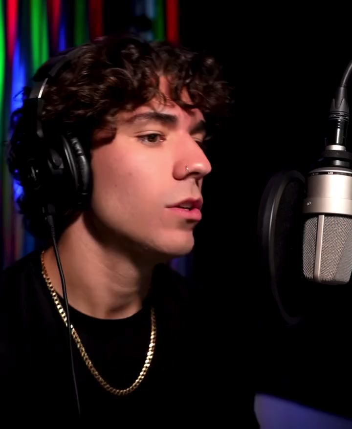 Cam Carroll singing beside his studio microphone